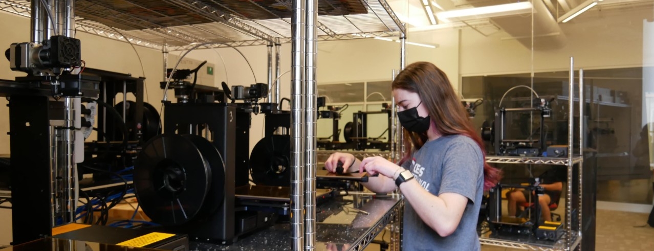 Student using 3D printer in the lab