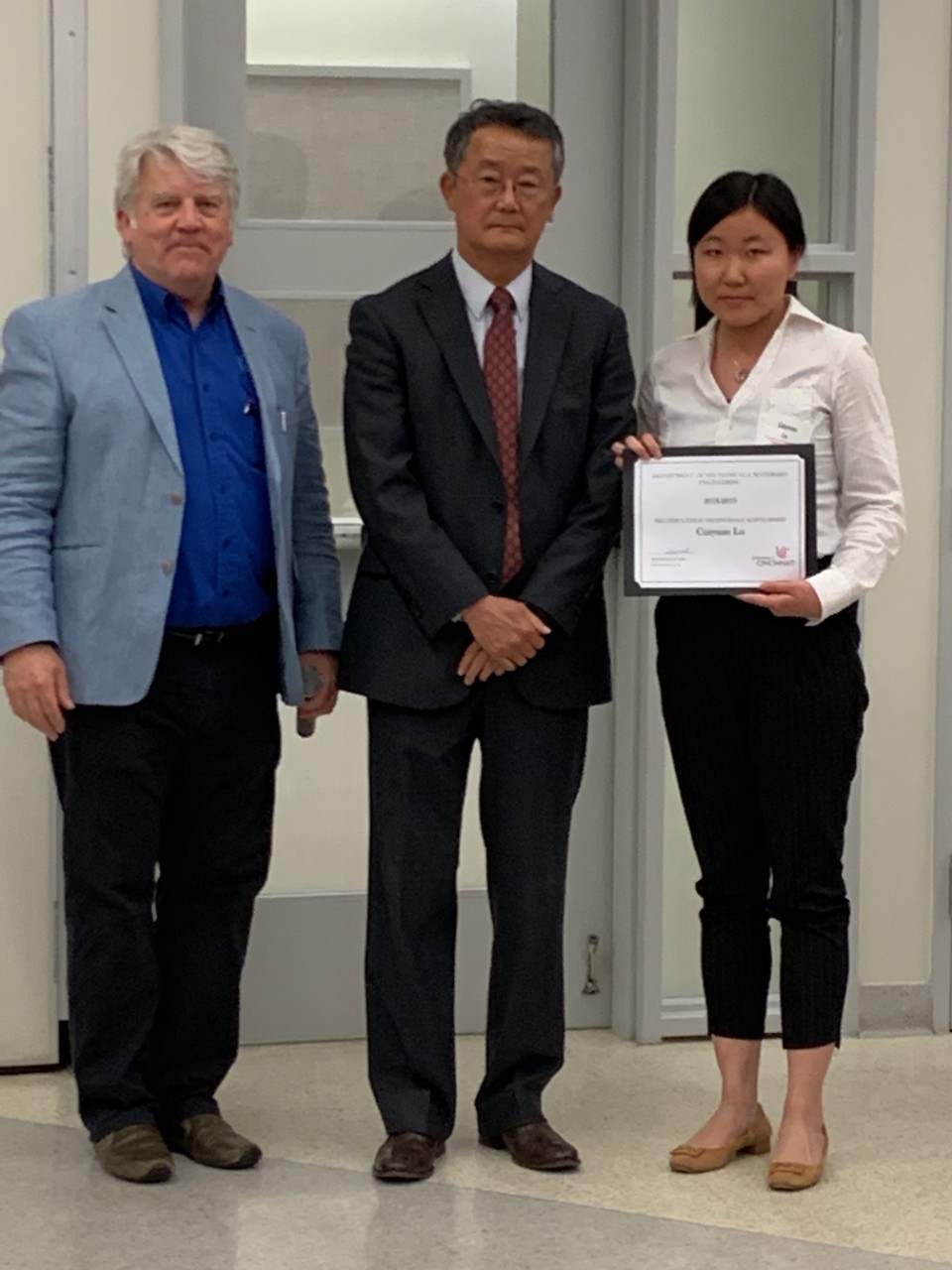 Fred Murrell, Dr. Jay Kim, and Cuiyuan Lu holding her award