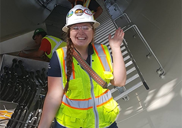 Brianna Karelin, construction management class of 2018, in a neon safety vest, hardhat, and safety glasses while on co-op.