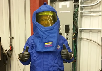 Nathan Huber, electrical engineering technology class of 2019, in a blue hazmat suit at his co-op assignment at Coldwater Machine. The suit protects him from high voltage