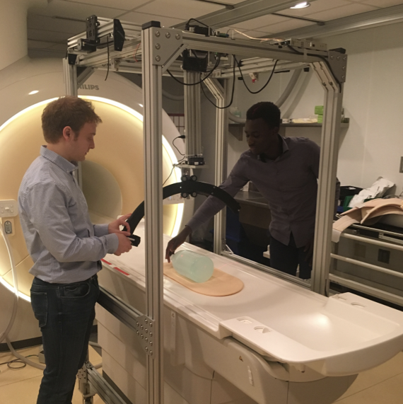 Two students setting up the MRI machine